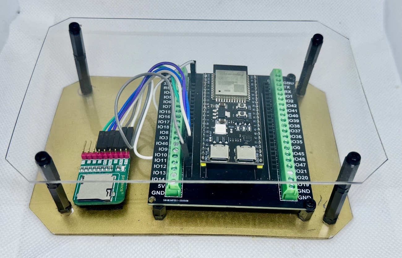 The PianoHack unit — ESP32-S3 board with micro-SD reader in a clear acrylic case
